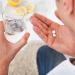 Man holding pills