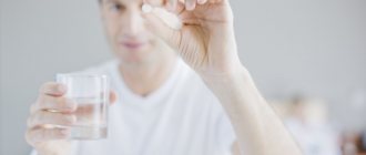 Man holding a pill in his hands